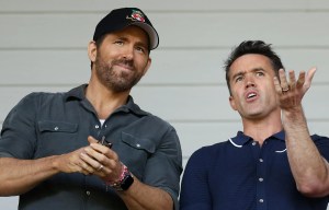 Ryan Reynolds and Rob McElhenney, co-owners of Wrexham AFC, react before a soccer match.
