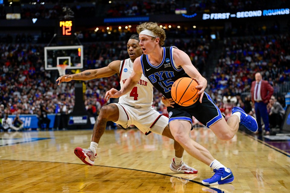 DENVER, COLORADO - MARCH 22: Richie Saunders #15 of the Brigham Young Cougars is defended by Kamari McGee #4 of the Wisconsin Badgers in the second half in the second round of the NCAA Men's Basketball Tournament at Ball Arena on March 22, 2025 in Denver, Colorado. (Photo by Dustin Bradford/Getty Images)